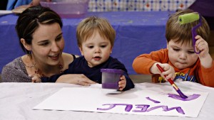 Young family working on homecoming banners